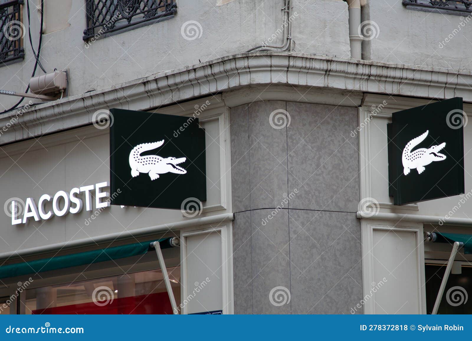 Lacoste Sign Text and Logo Brand on Wall Facade Entrance on Fashion ...