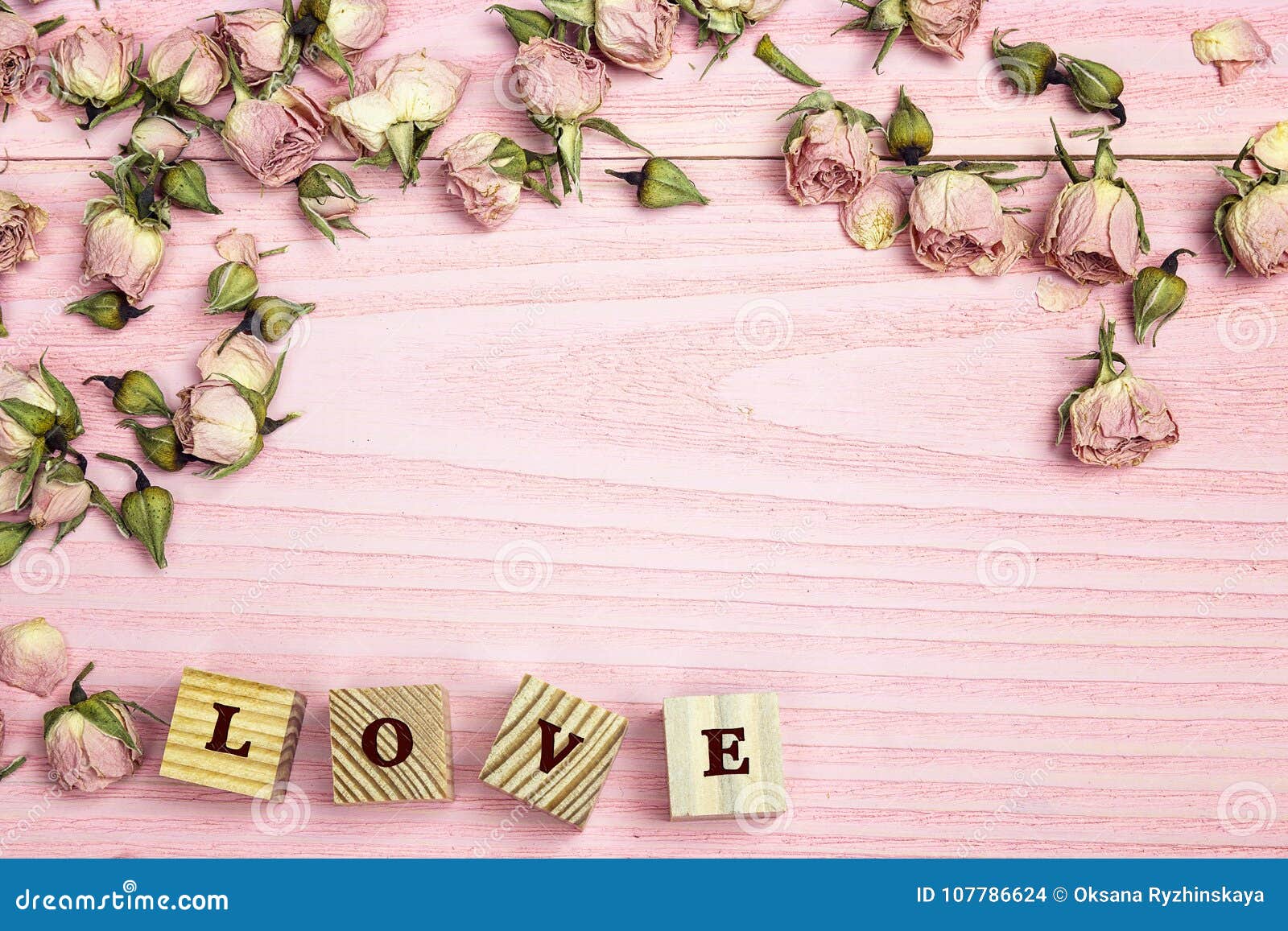 Border Of Rose Flowers And Word Love On The Pink Wooden Background With ...