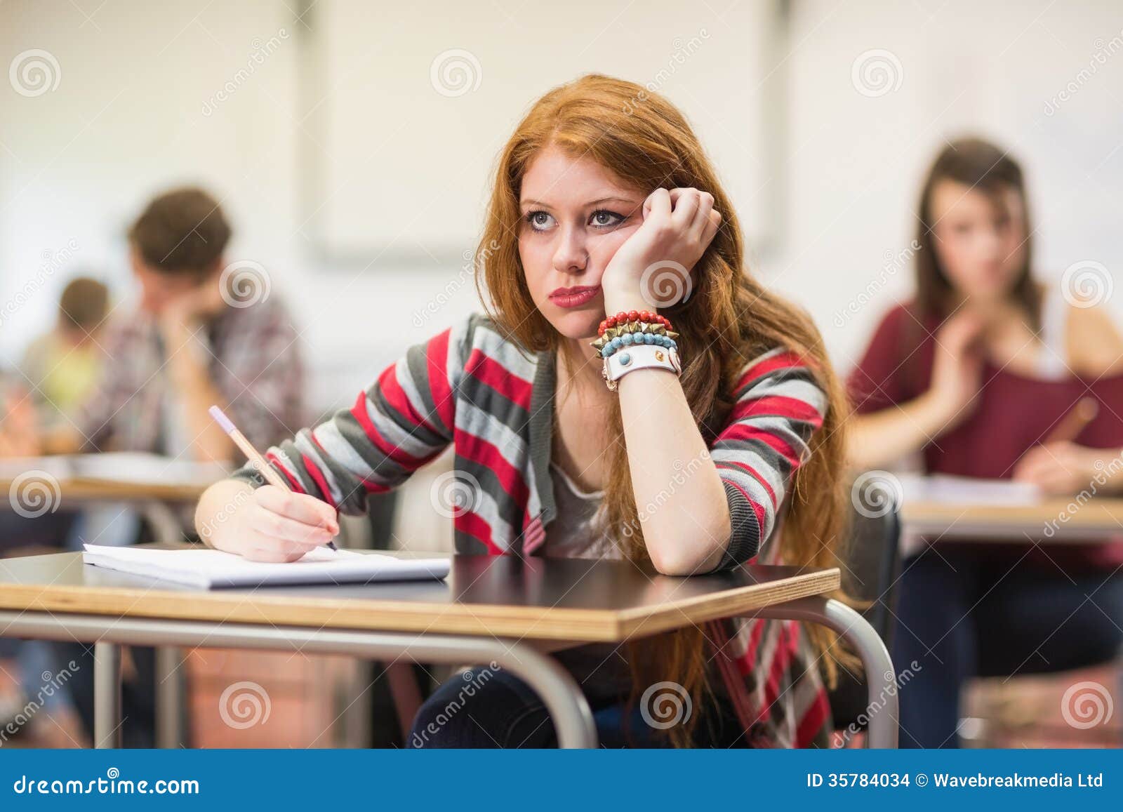 bored female student others writing notes classroom young 35784034