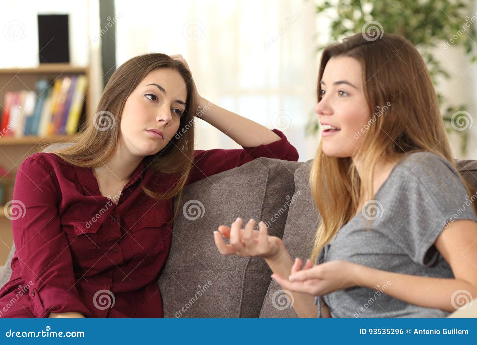 bored girl listening to her friend having a conversation