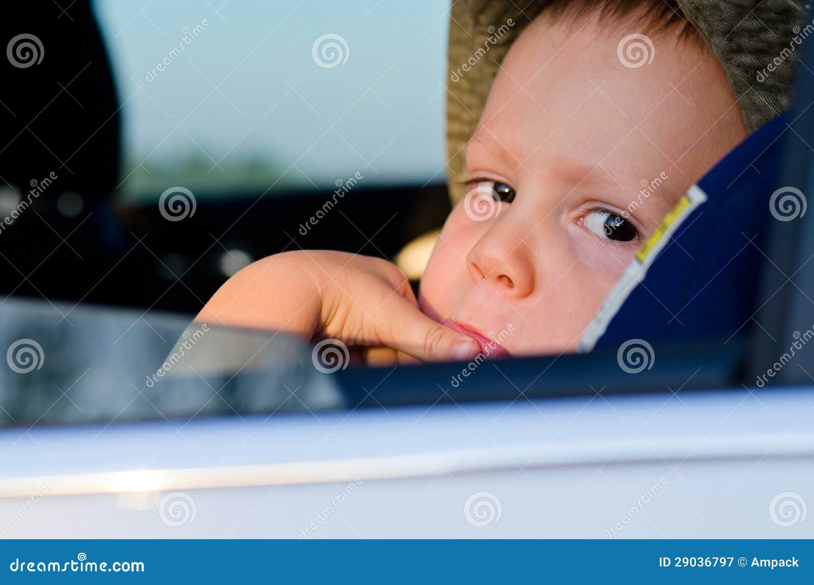 Bored little boy in a car stock image. Image of trip 29036797
