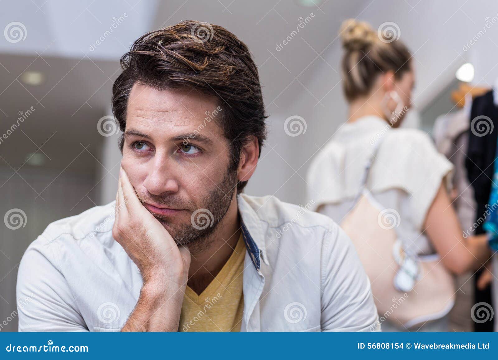 bored man sitting in front of his girlfriend
