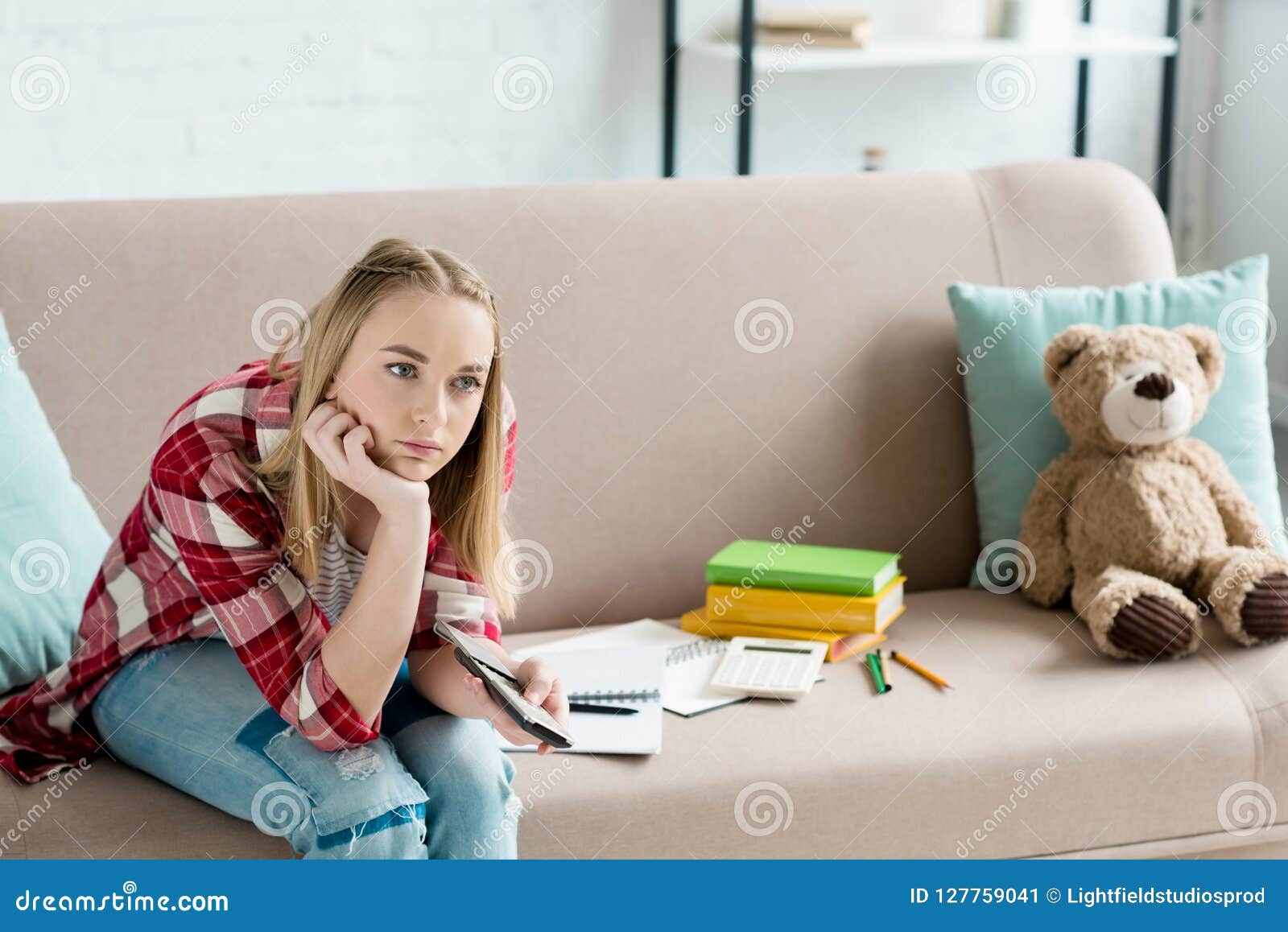 Bored Teen Student Girl With Remote Control Watching Tv While Sitting