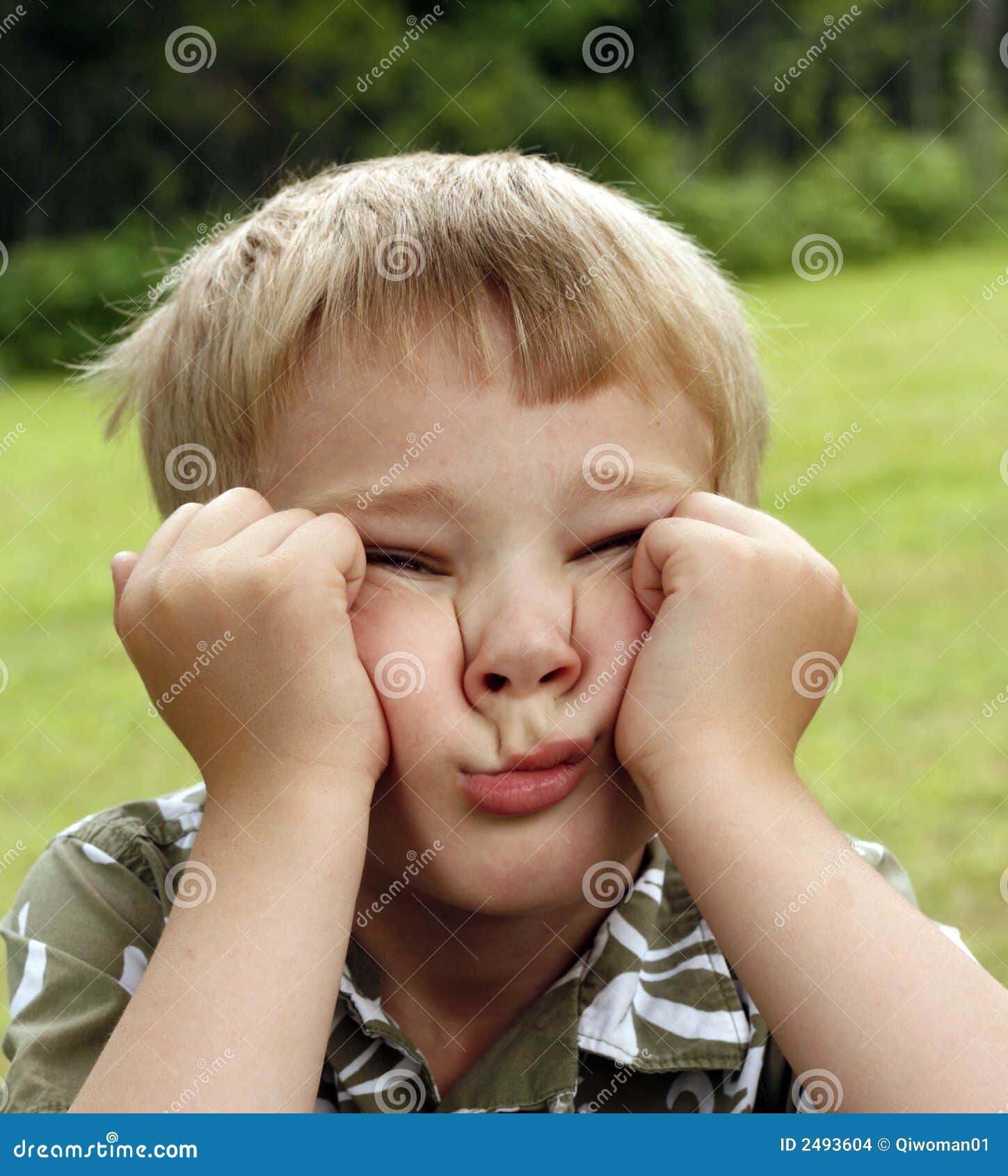 Young child scrunches up his face in boredom.