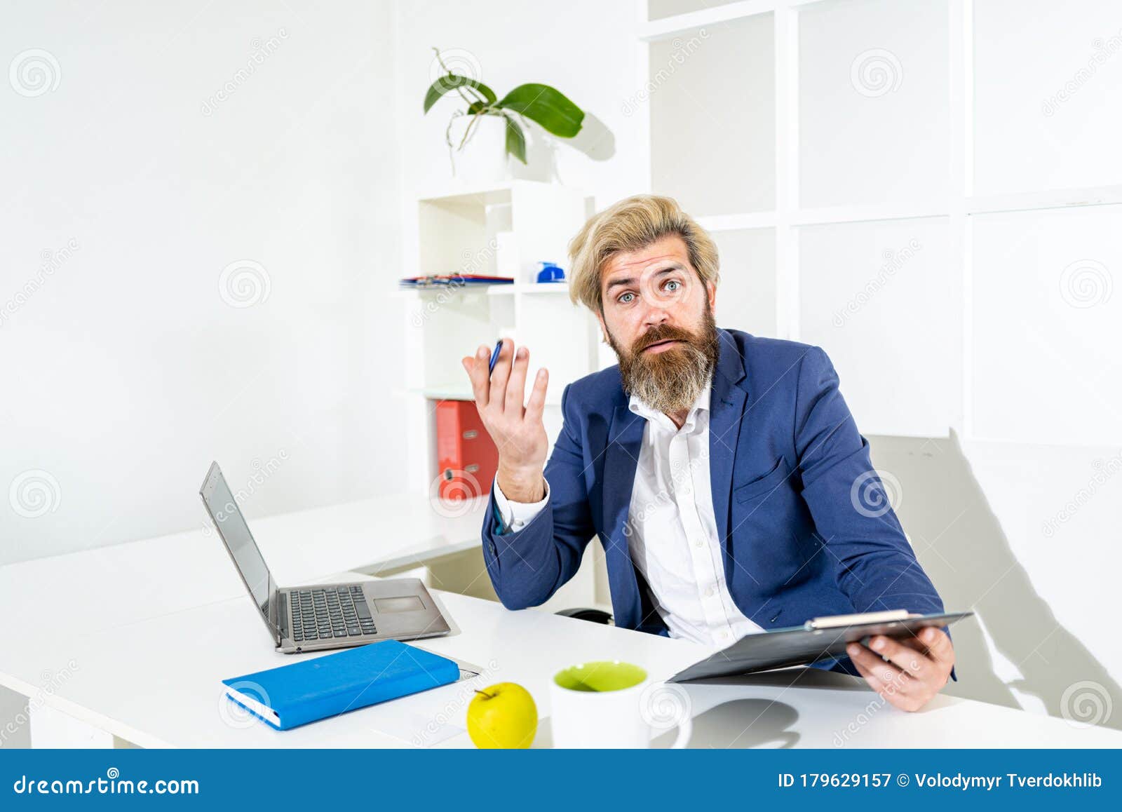 Boring Job Portrait Of Young Man Sitting At His Desk In The