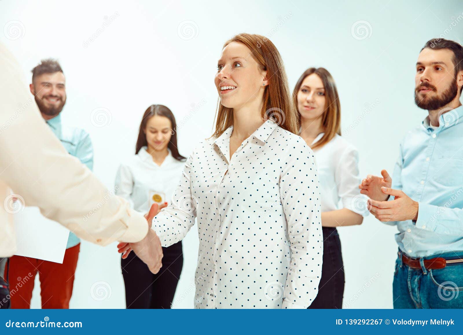boss approving and congratulating young successful employee