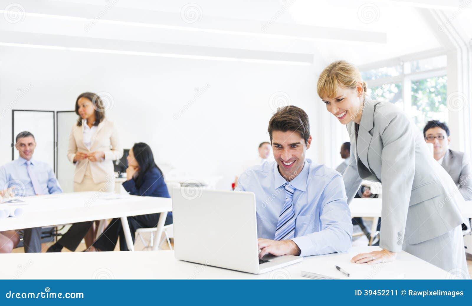 a boss guiding employee in front of the laptop