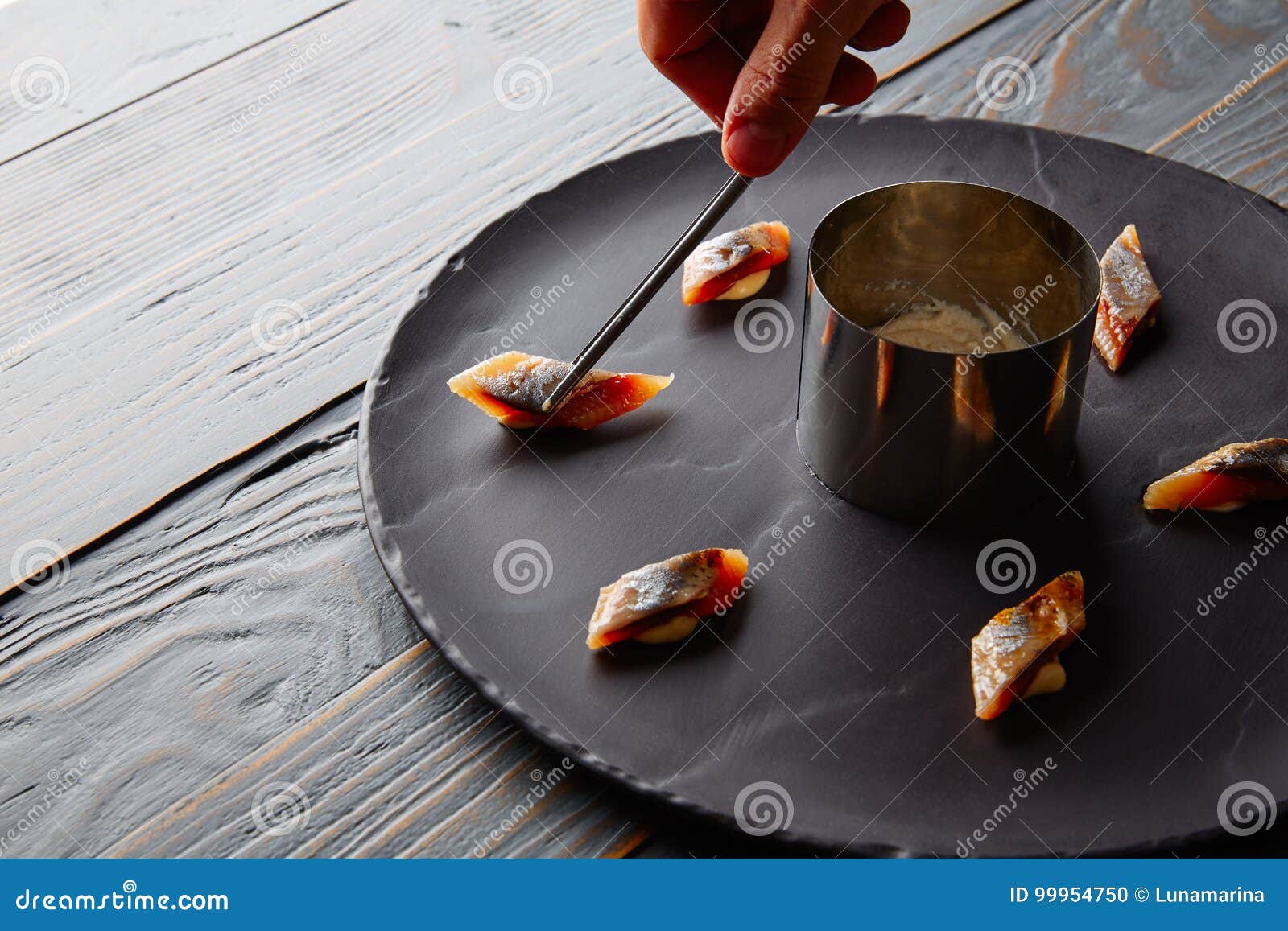 bota sardine preparation with chef hand