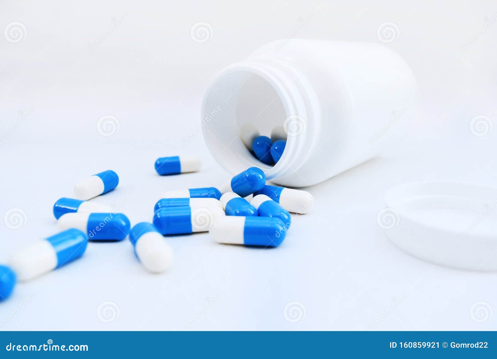 bottle of blue and white pills. medicine. medication