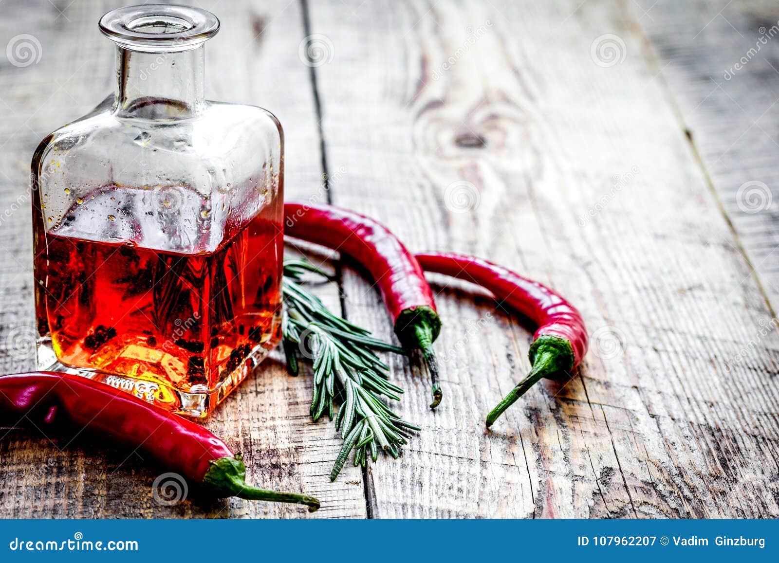 Download Bottle With Chili Oil And Herbs On Wooden Background Mock ...