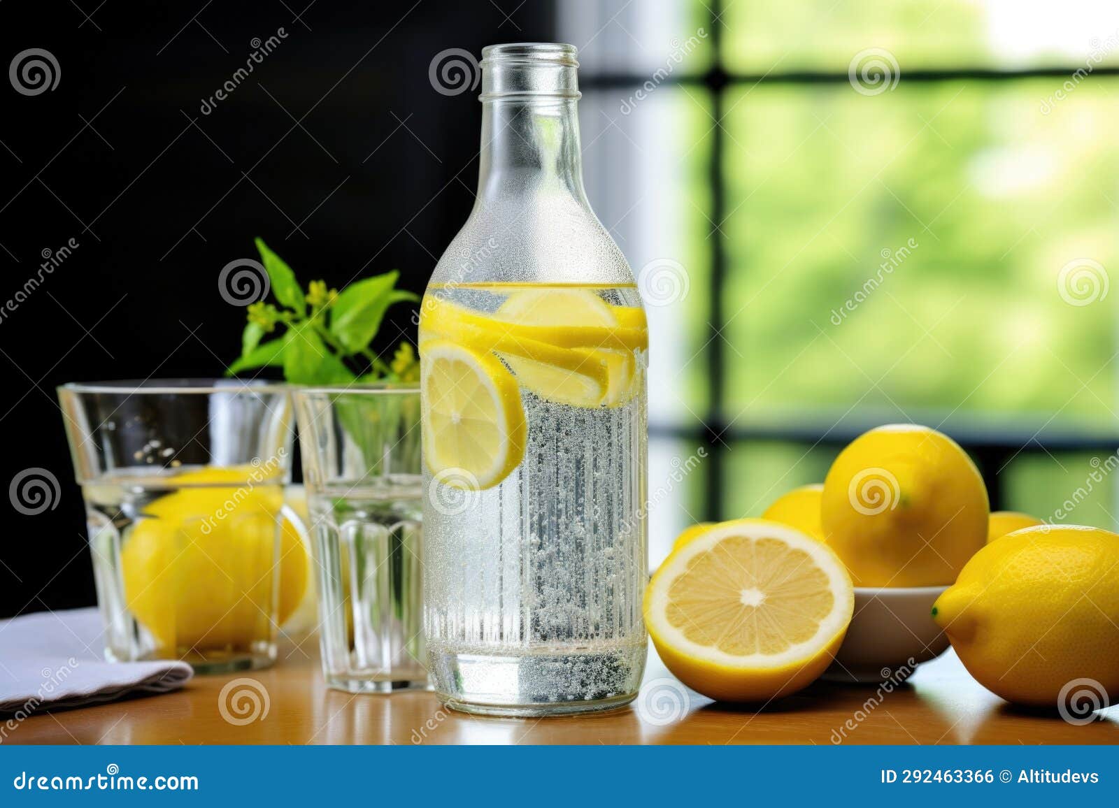 A Bottle of Club Soda Positioned with Fresh Lemons Stock Photo Image