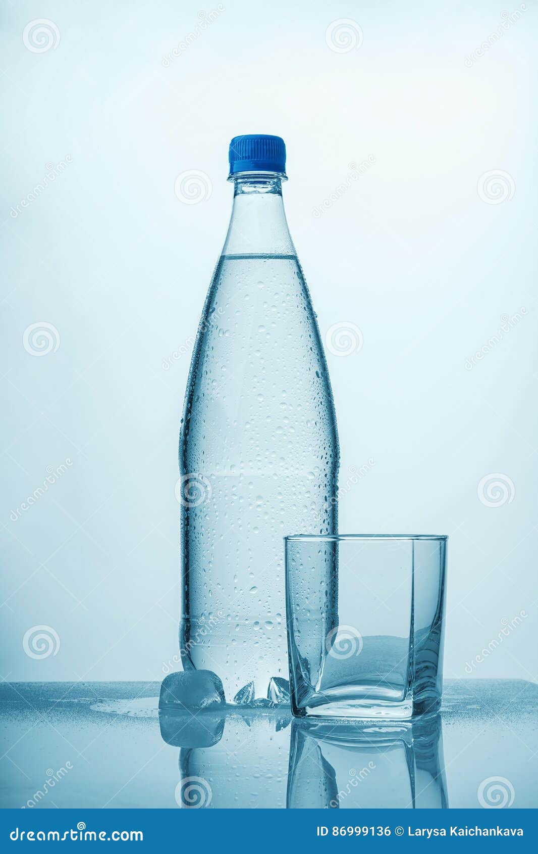 A Bottle of Cold Water, Ice and an Empty Glass Stock Photo Image of
