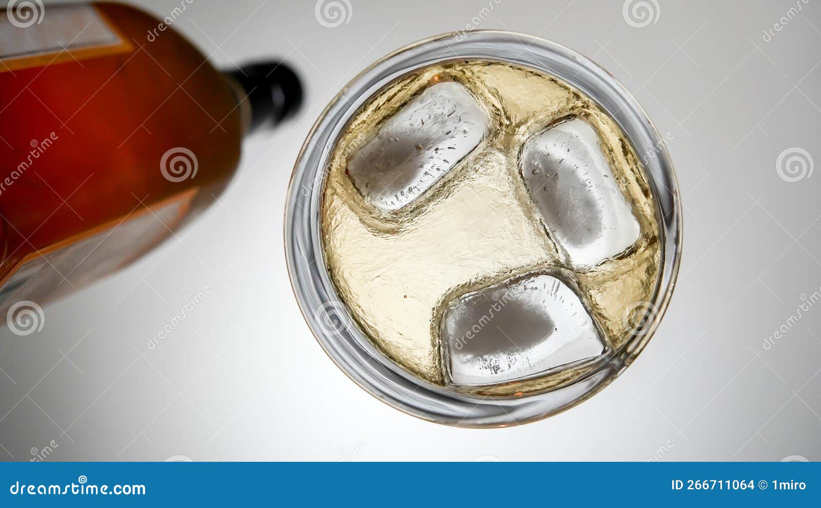 Bottle with Drink and Ice on Table from Low Angle Stock Photo Image