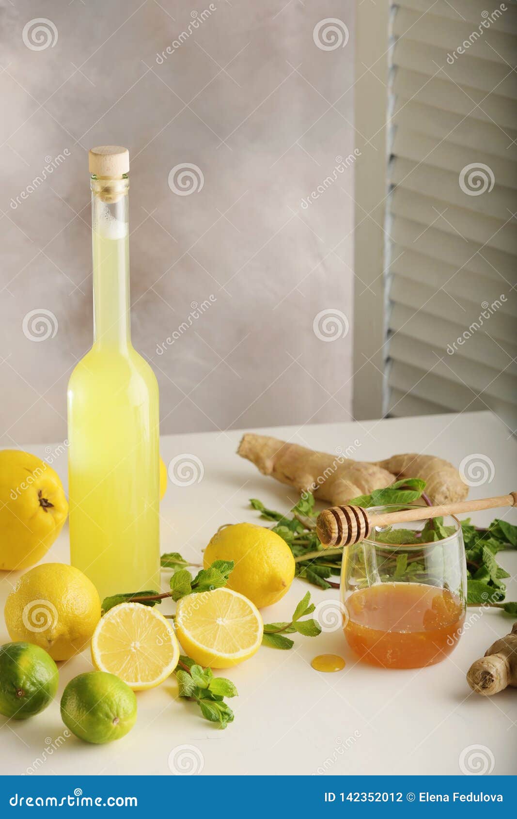 Bottle of Homemade Juice with Ginger and Lemon on Light Background