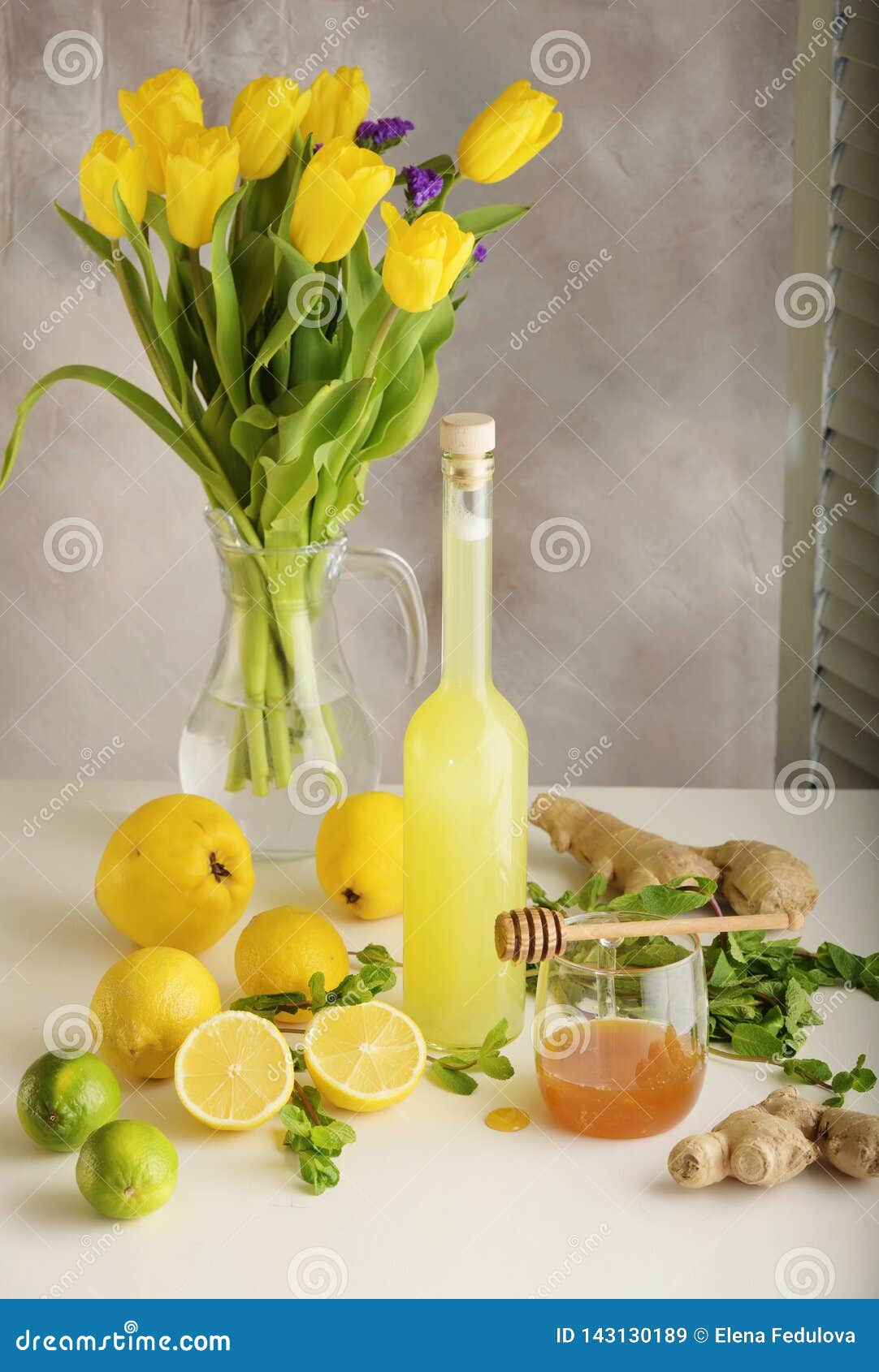 Bottle of Homemade Juice with Ginger and Lemon on Light Background