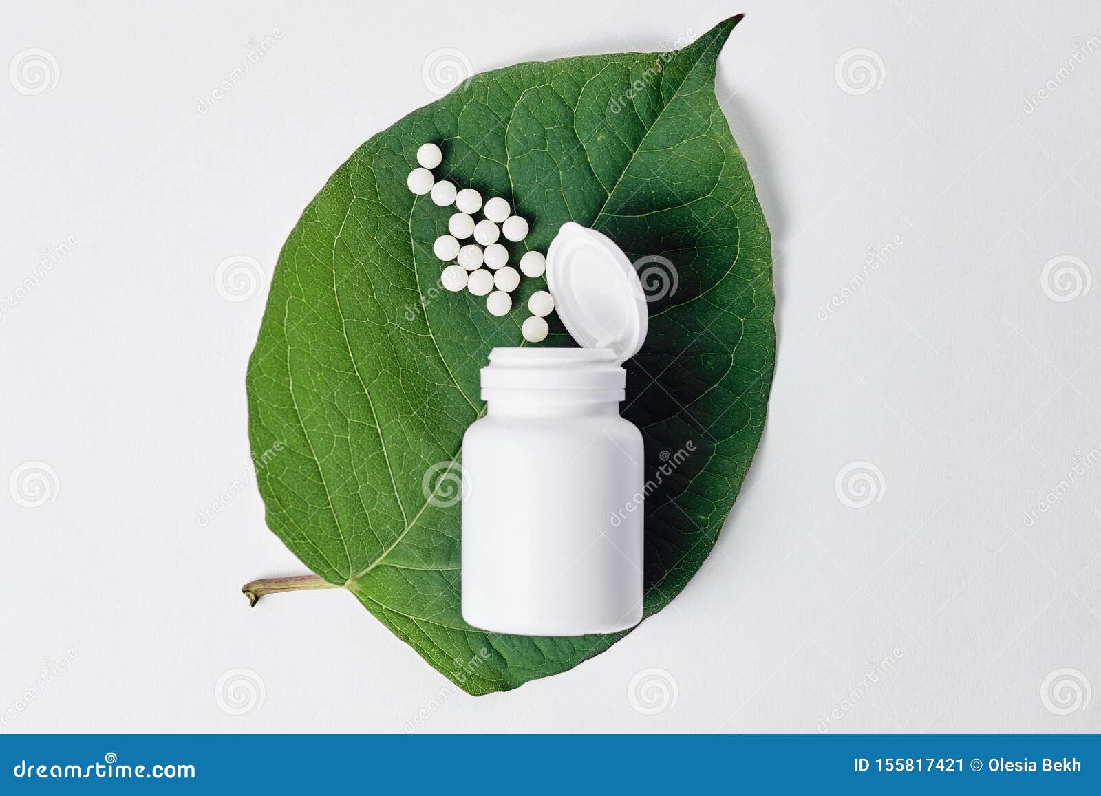 Bottle with Homeopathic Pills on Green Plant Leaf. Homeopathy ...