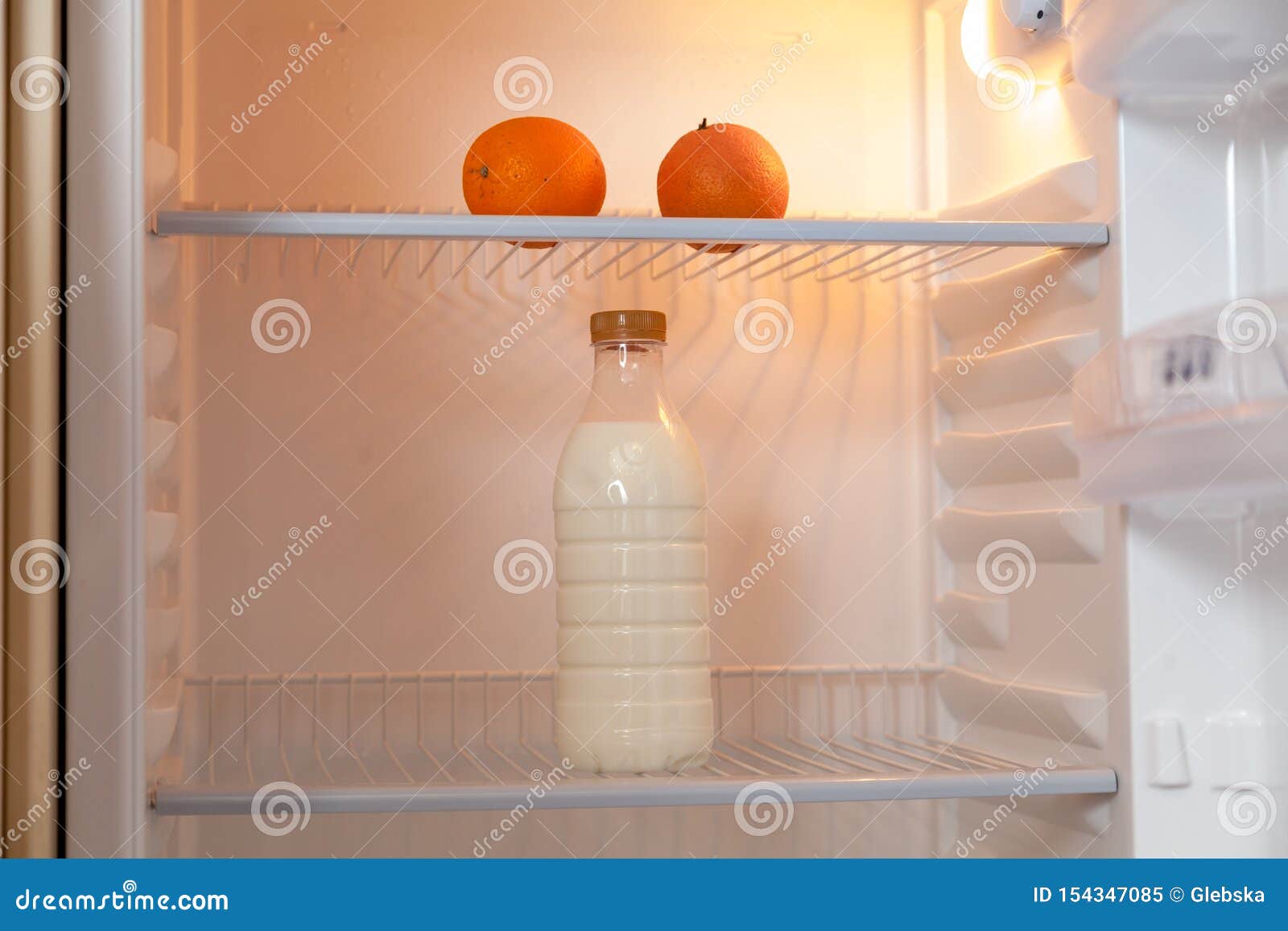Bottle of Milk and Oranges Stand in Empty Fridge Stock Image Image of life, creative 154347085