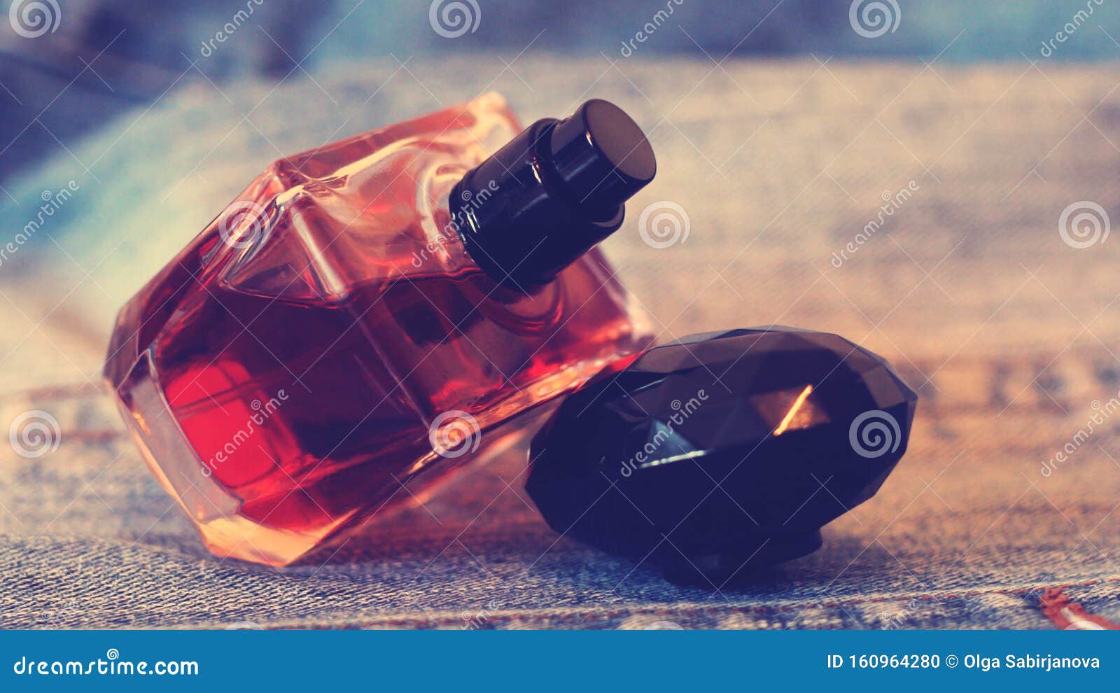 Bottle of Perfume on the Jeans, Brown Color, Brown Toned Stock Photo