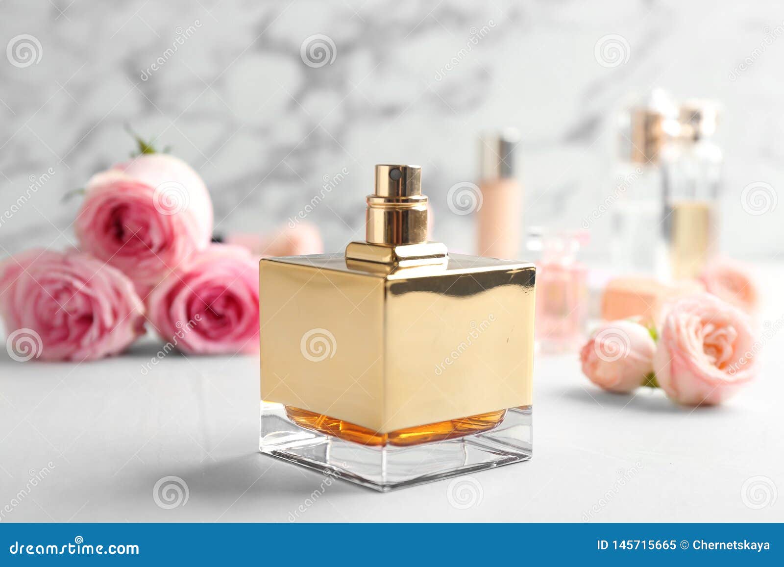 Bottle of Perfume and Roses on Table Against Marble Stock Image - Image ...