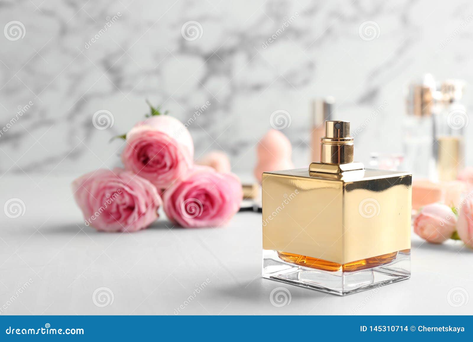 Bottle of Perfume and Roses on Table Against Marble Background Stock ...