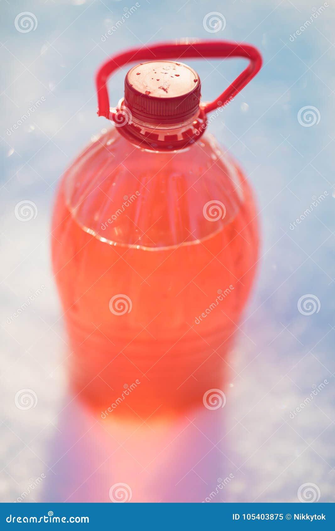 bottle with non-freezing windshield washer fluid, snow background