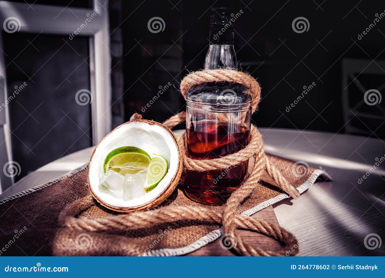 Bottle of Rum with Lime Ice and Coconut, Coconut Glasses and Rum Stock