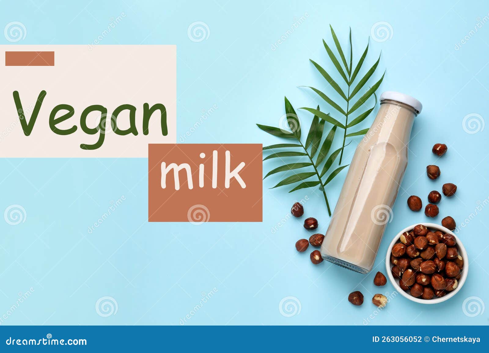 Bottle of Vegan Milk and Hazelnuts on Light Blue Background, Flat Lay