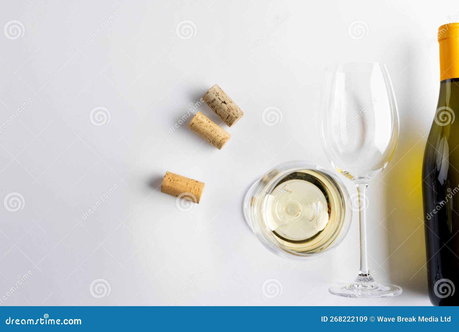 Bottle of White Wine, Glasses and Corks on White Background, with Copy