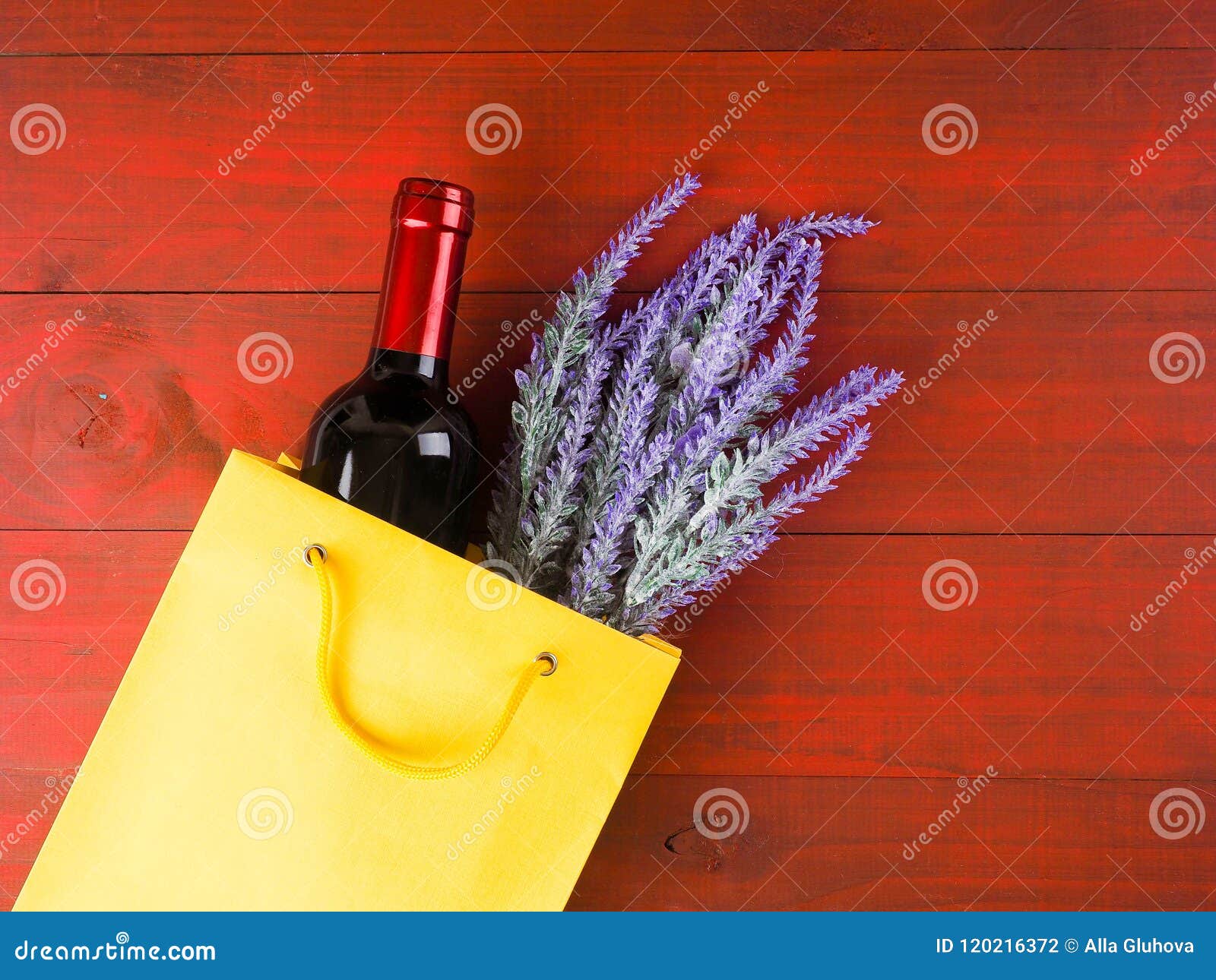 Bottle of Wine and Flowers in the Package on Wooden Background, Space for Text Stock Photo