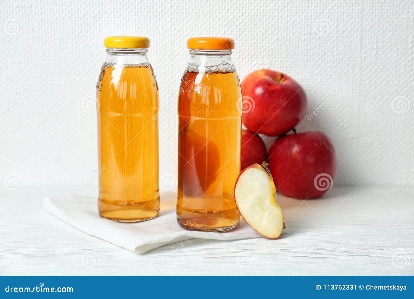 Bottles of apple juice stock image. Image of napkin 113762331