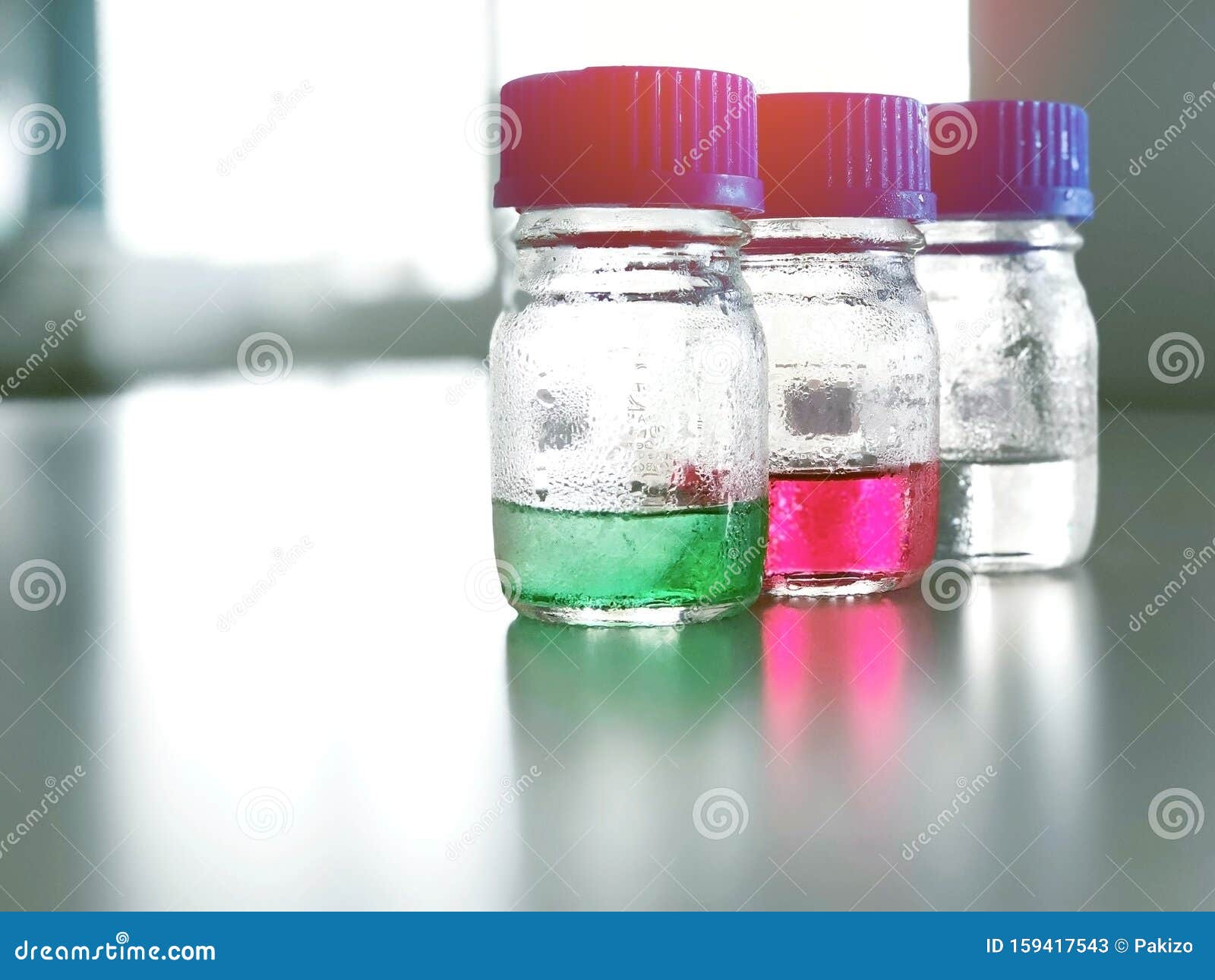Bottles And Blue Cap With Green Red And Clear Solution Buffer Ph