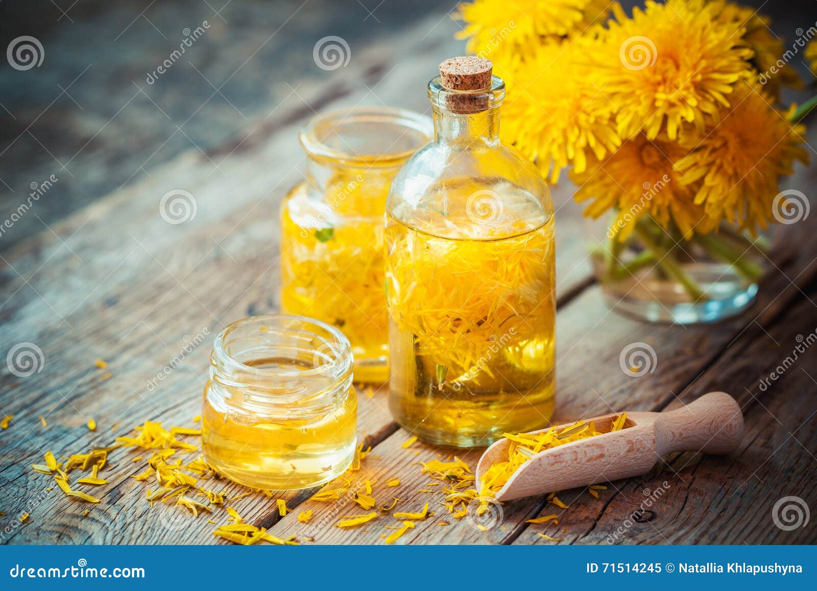 bottles of dandelion tincture or oil and flower bunch