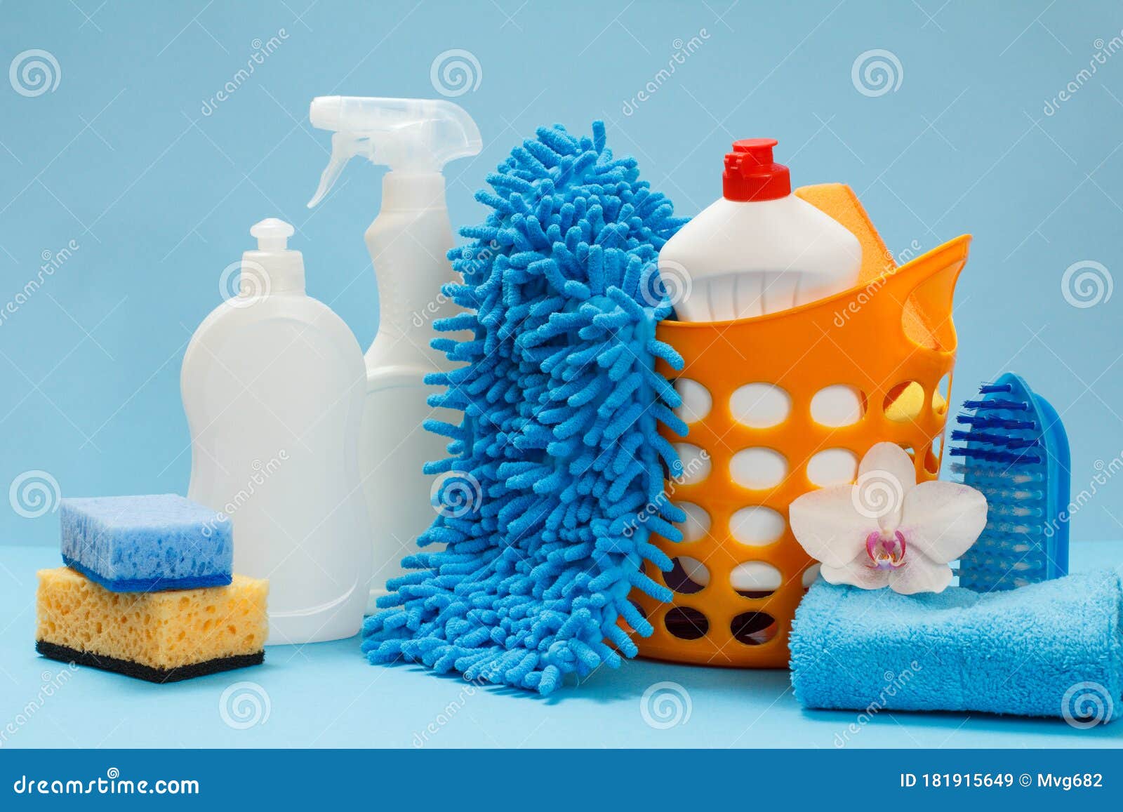 Basket with cleaning products on blue background. Cleaning with