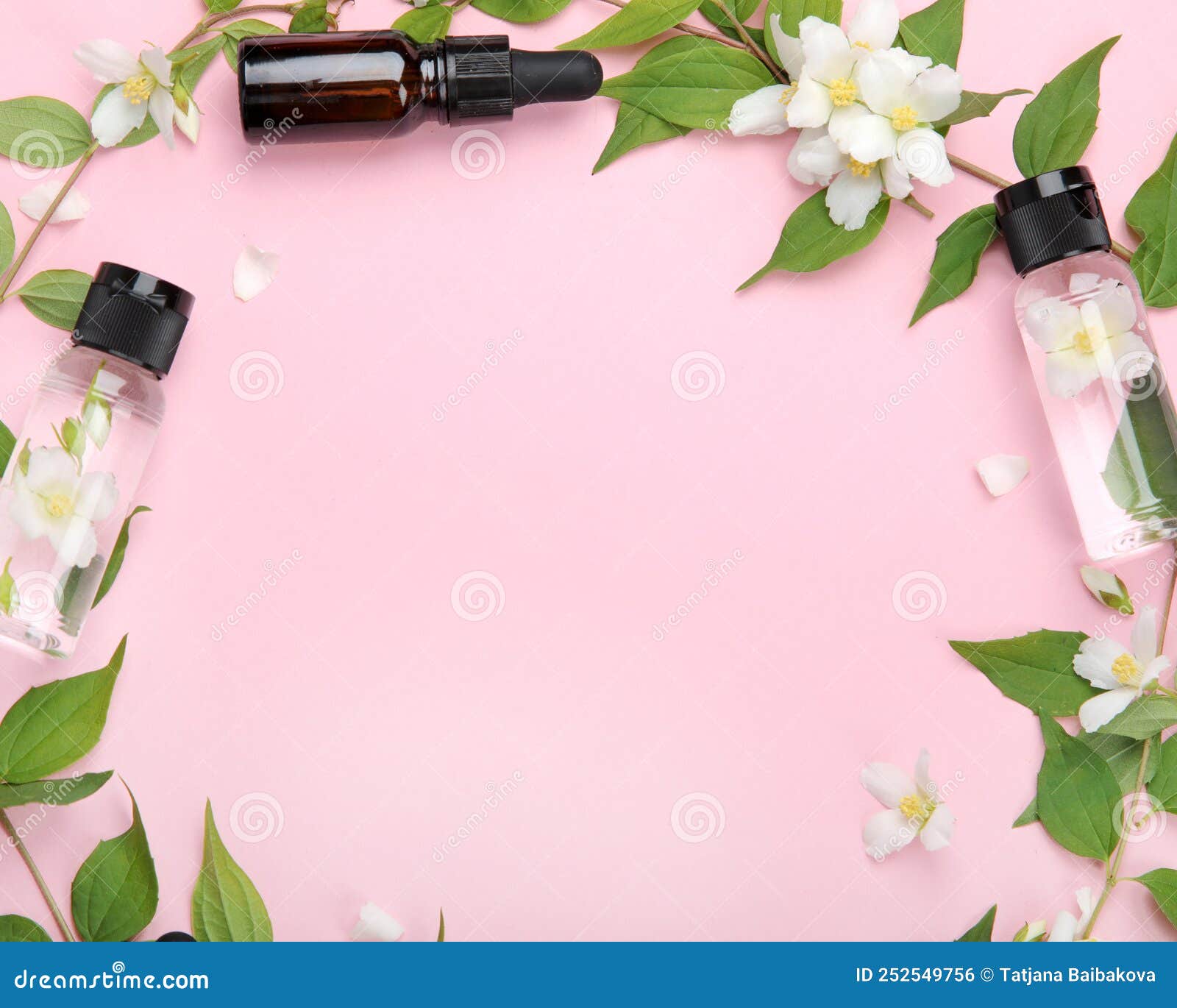 bottles of essential oil with jasmine flowers