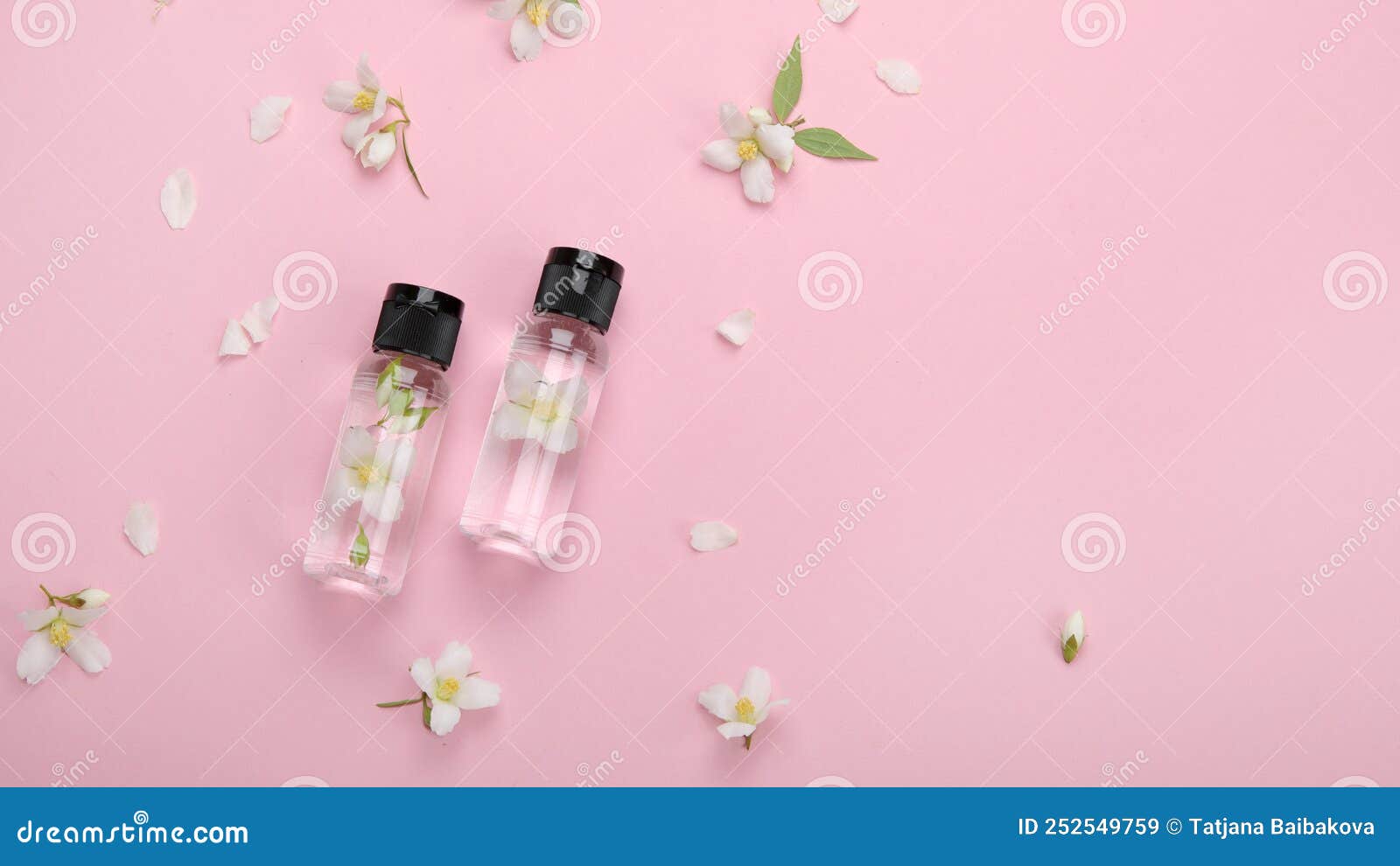 bottles of essential oil with jasmine flowers