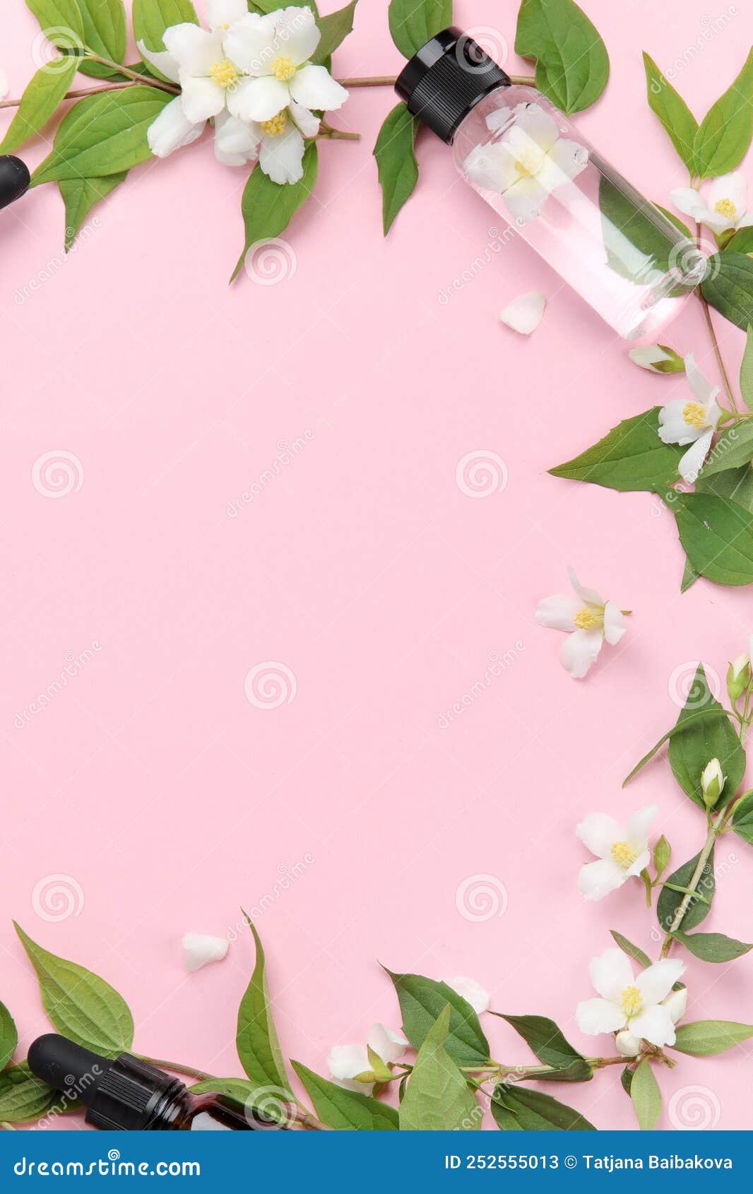 bottles of essential oil with jasmine flowers