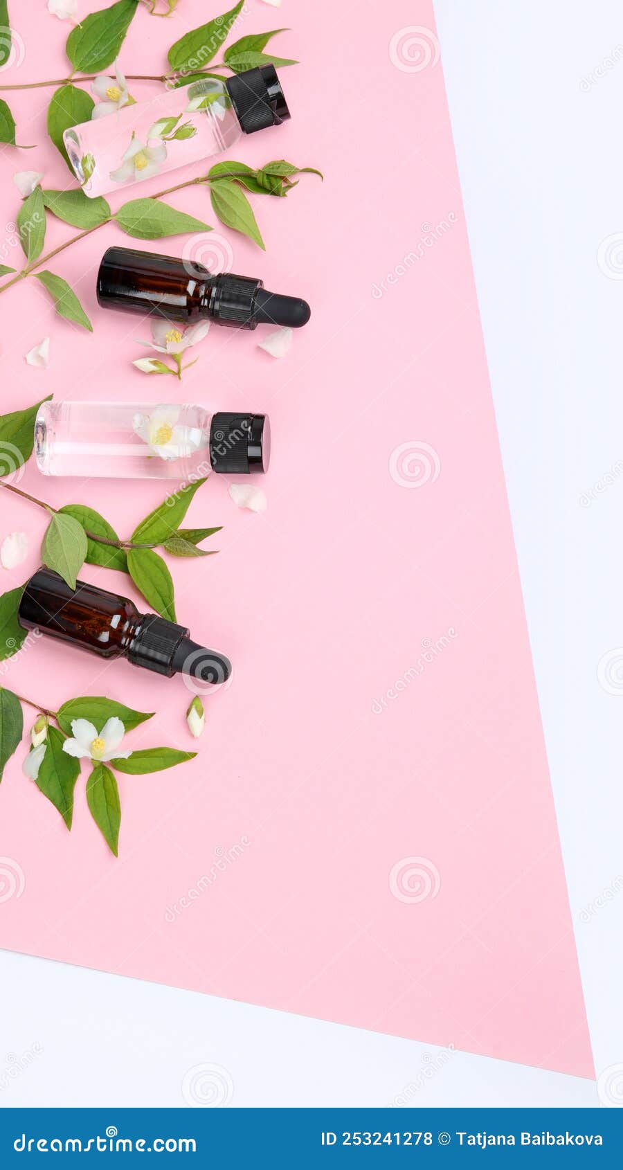 bottles of essential oil with jasmine flowers