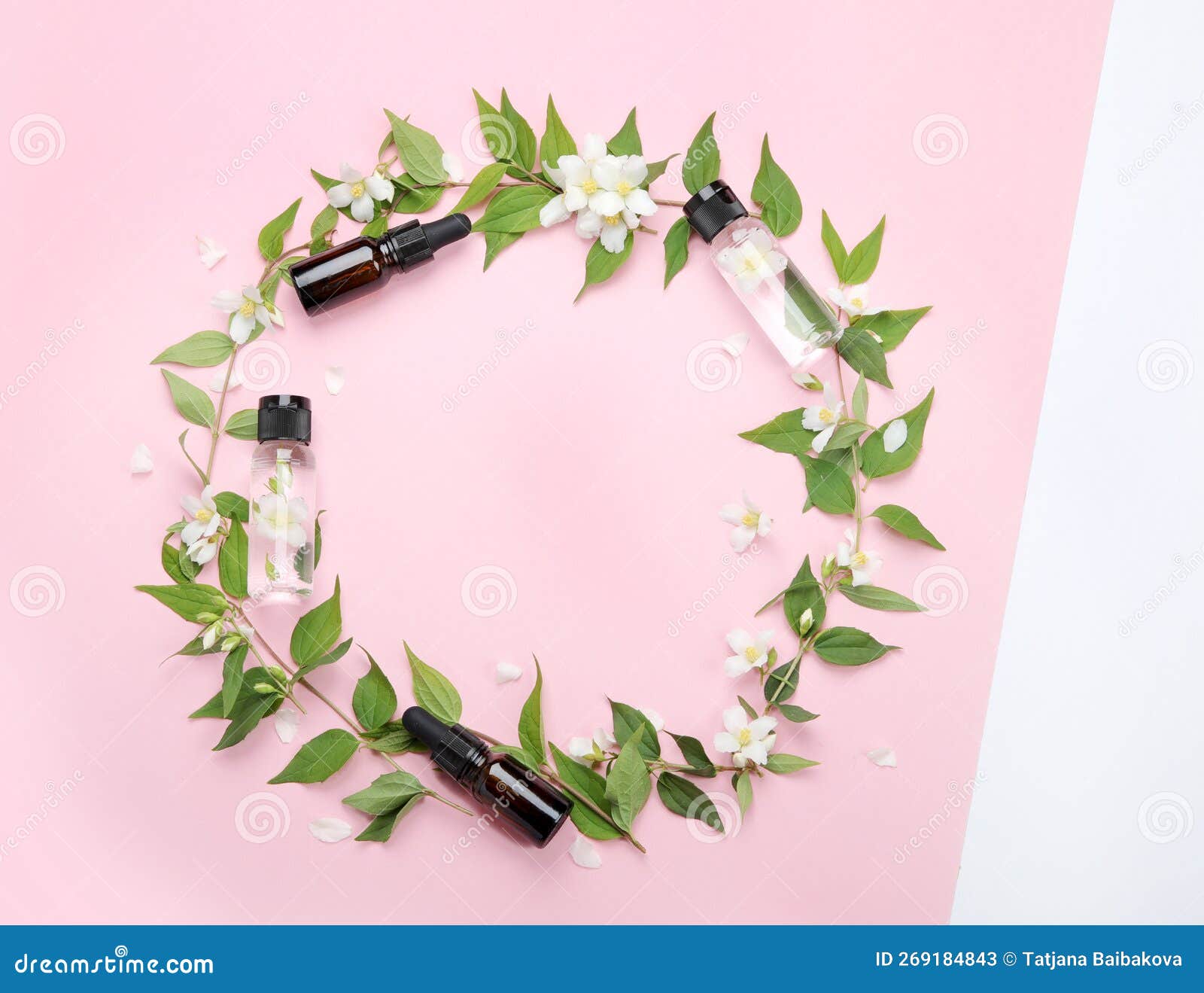 bottles of essential oil with jasmine flowers