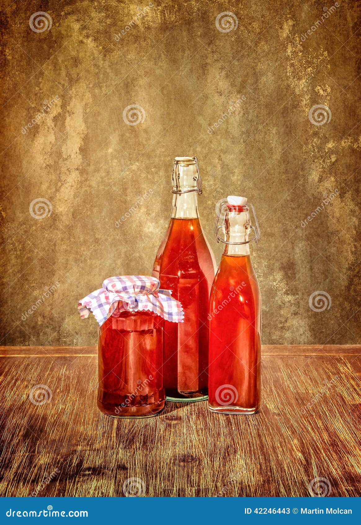 Bottles Filled with Yellow Syrup and Jam on Kitchen Table Stock Image