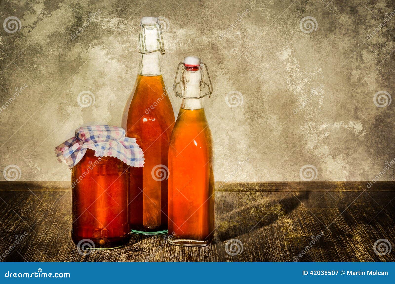 Bottles Filled with Yellow Syrup and Jam on Kitchen Table Stock Image