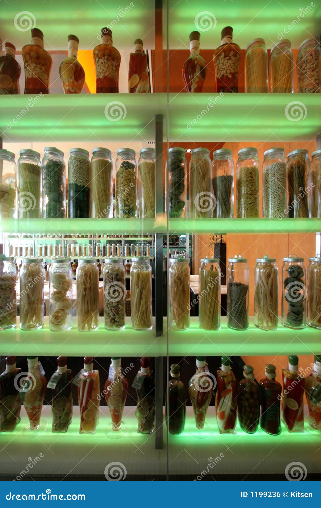 Shelves of multi-colored pasta in bottles &amp; jars