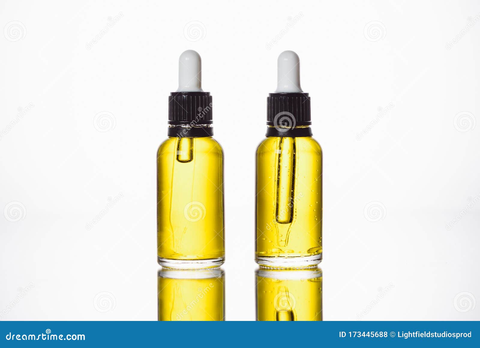 Bottles with Natural Serum on Surface with Reflection Isolated on White