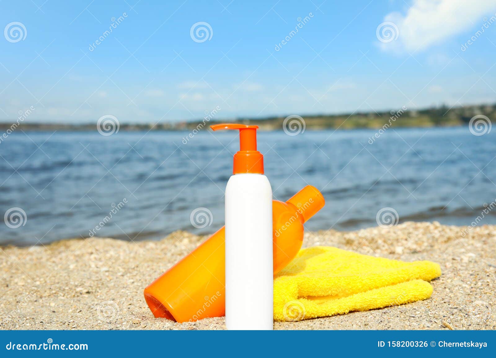Bottles of Sun Protection Body Cream and Towel on Beach Stock Photo ...