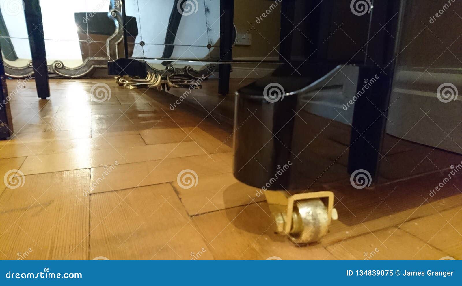 The Bottom Of A Shiny Black Piano With Polished Golden