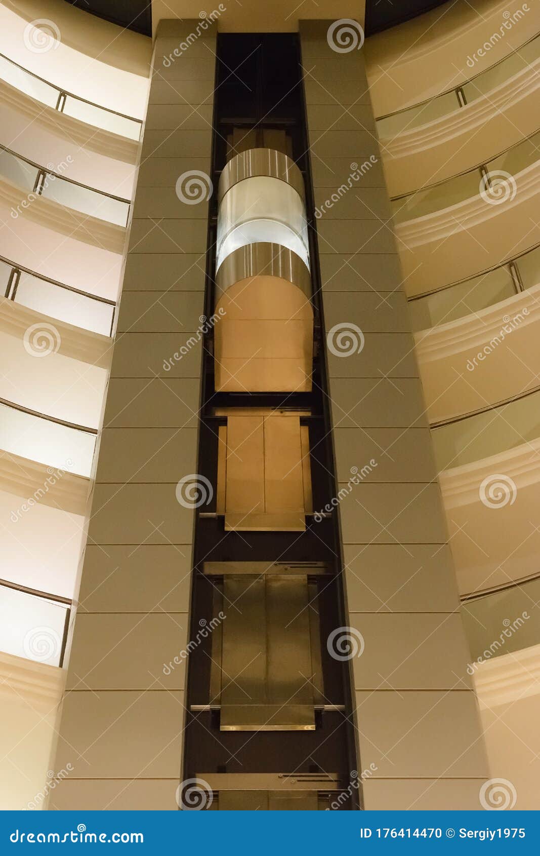 Bottom View of a Modern Glass Elevator Inside a Modern Building Stock