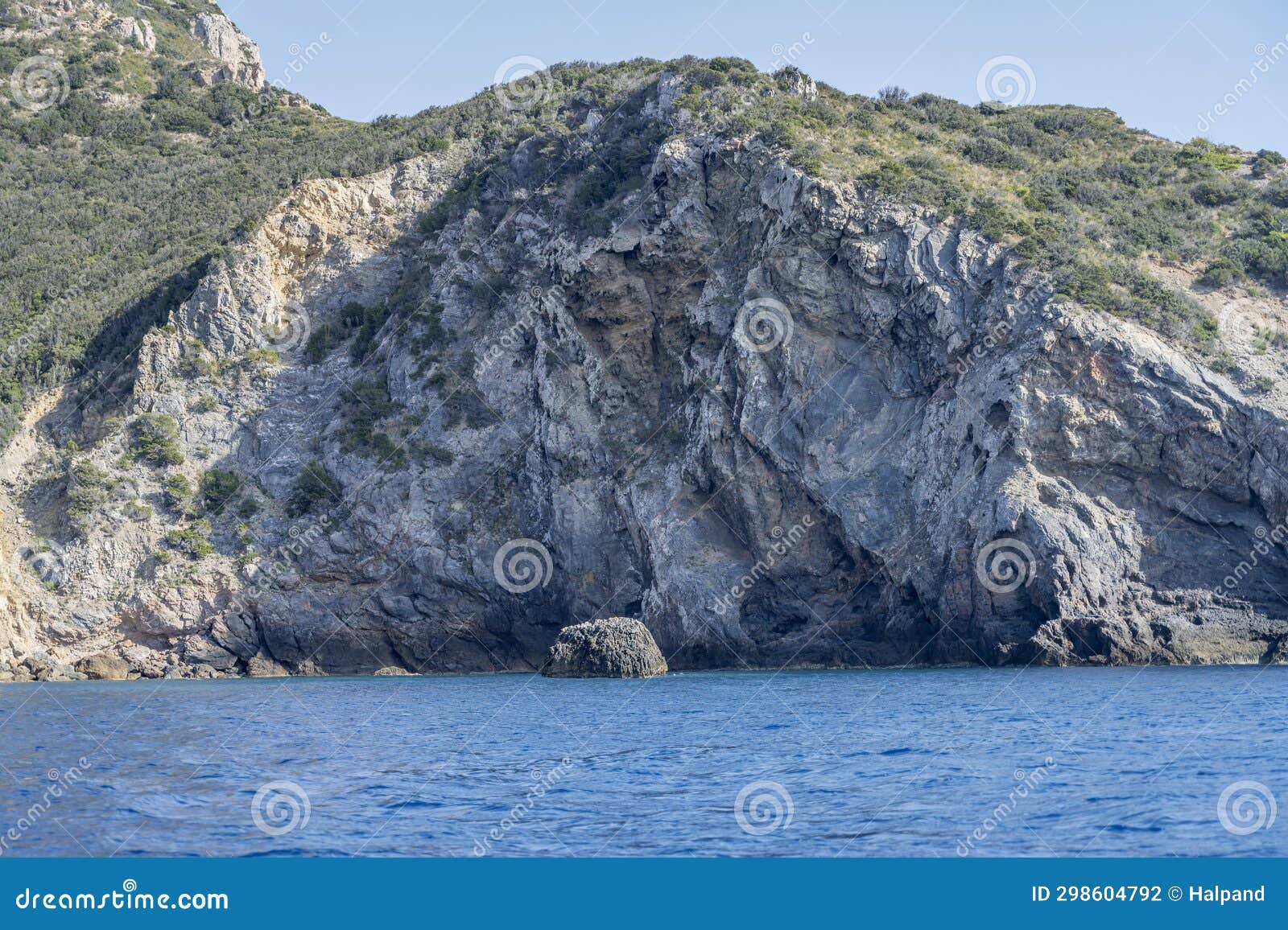 boulder and steep cliffs near uomo cape, argentario, italy