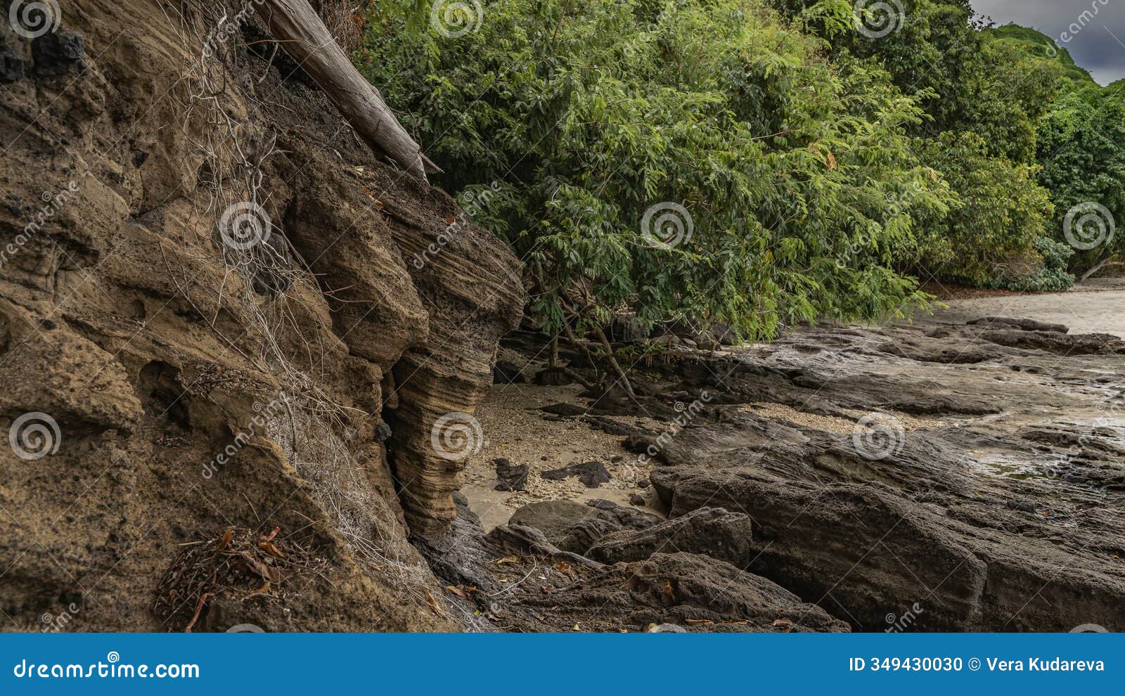 boulders were exposed at low tide in the ocean.