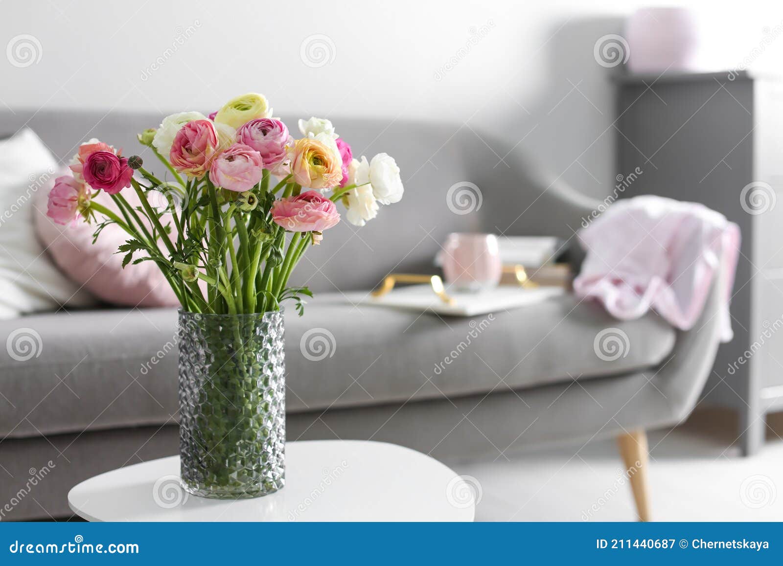 bouquet of beautiful ranunculuses on table in living room. space for text