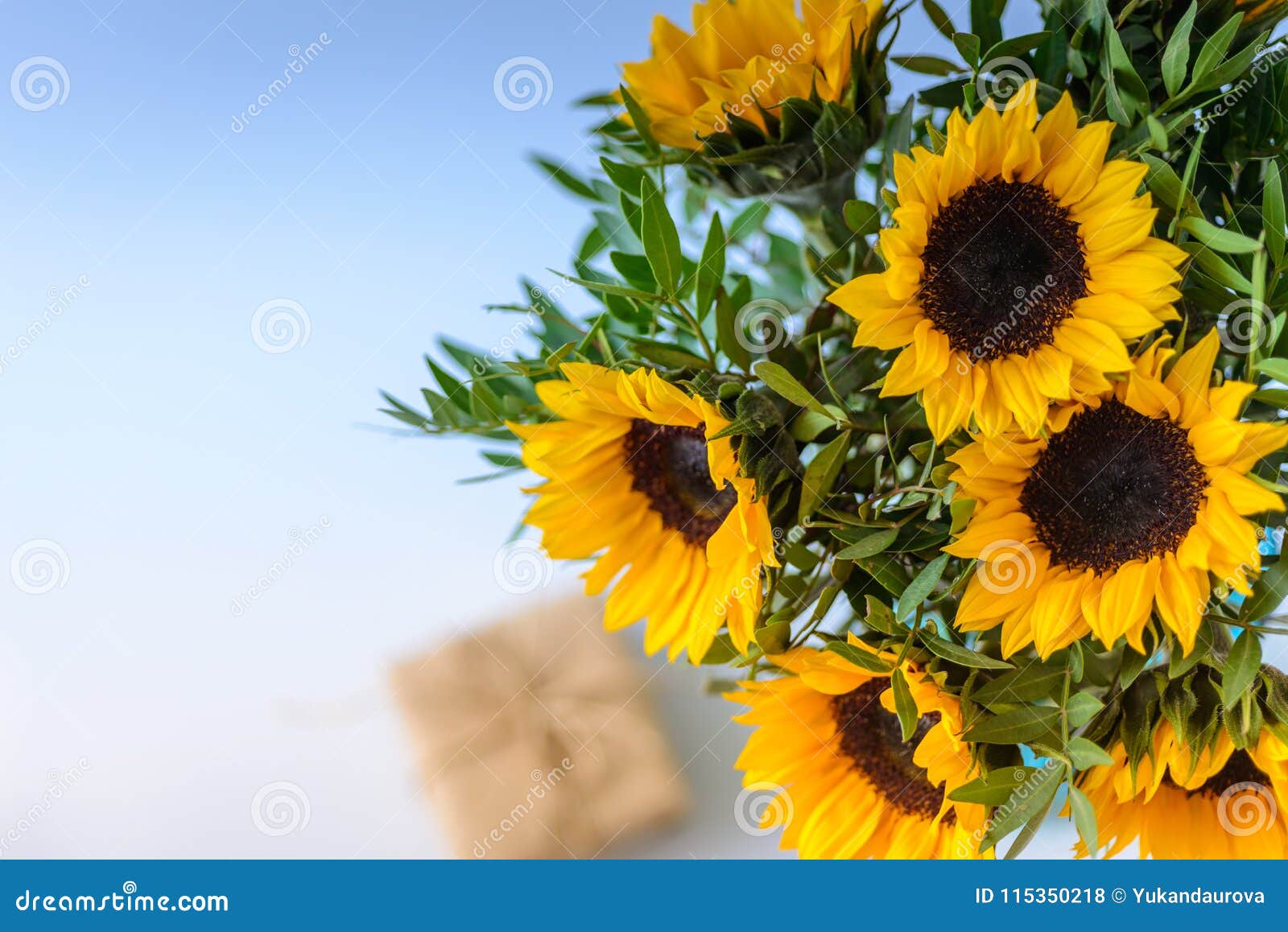 bouquet of bright sunflowers with gift box.