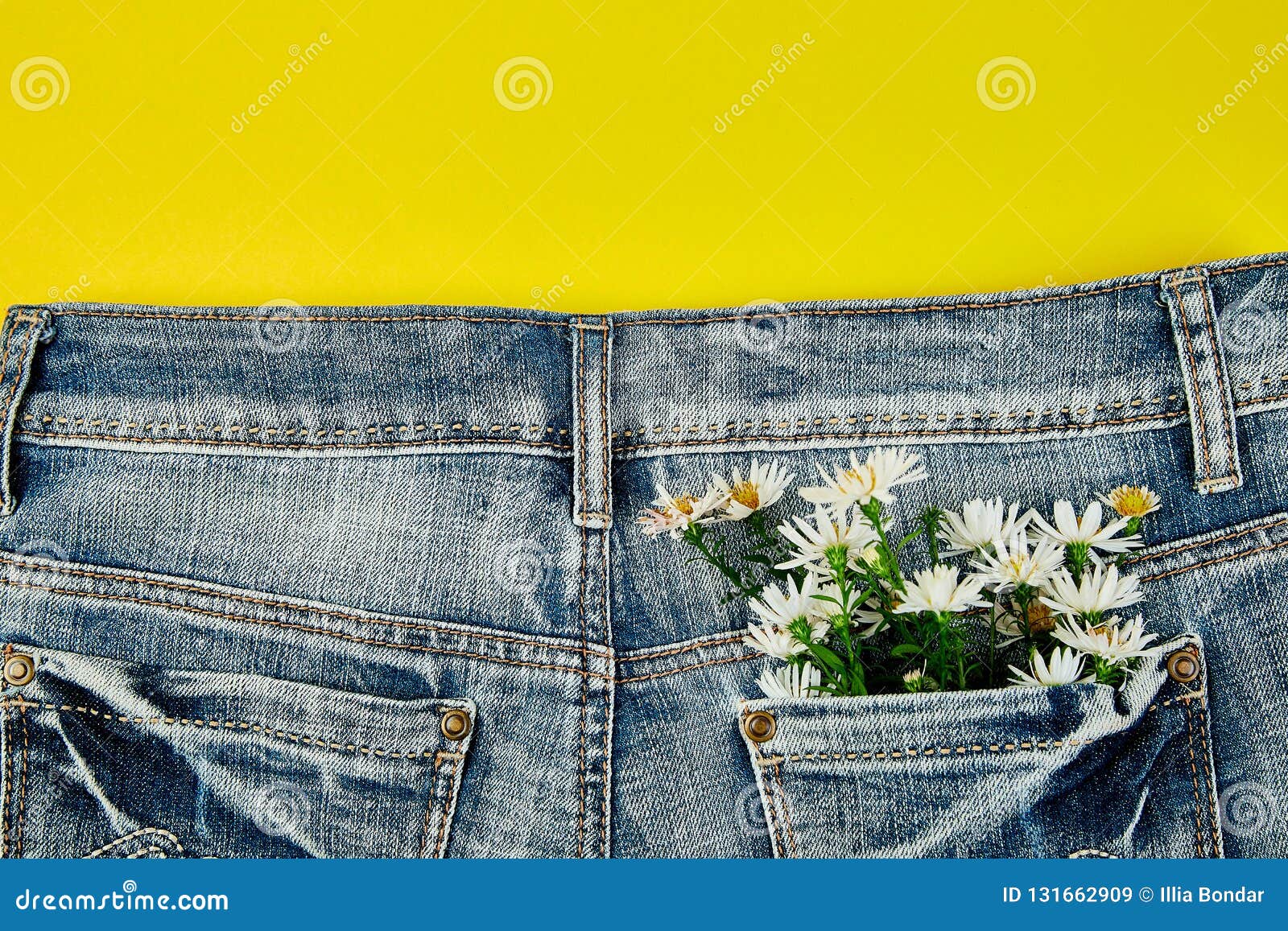 Bouquet of White Flower in the Pocket of a Jeans on Yellow Background ...